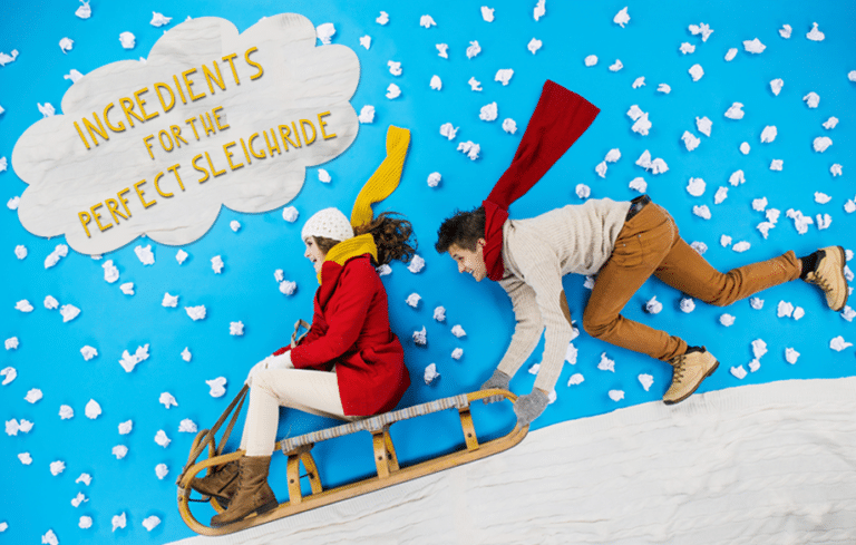 Two people playing on a sleigh
